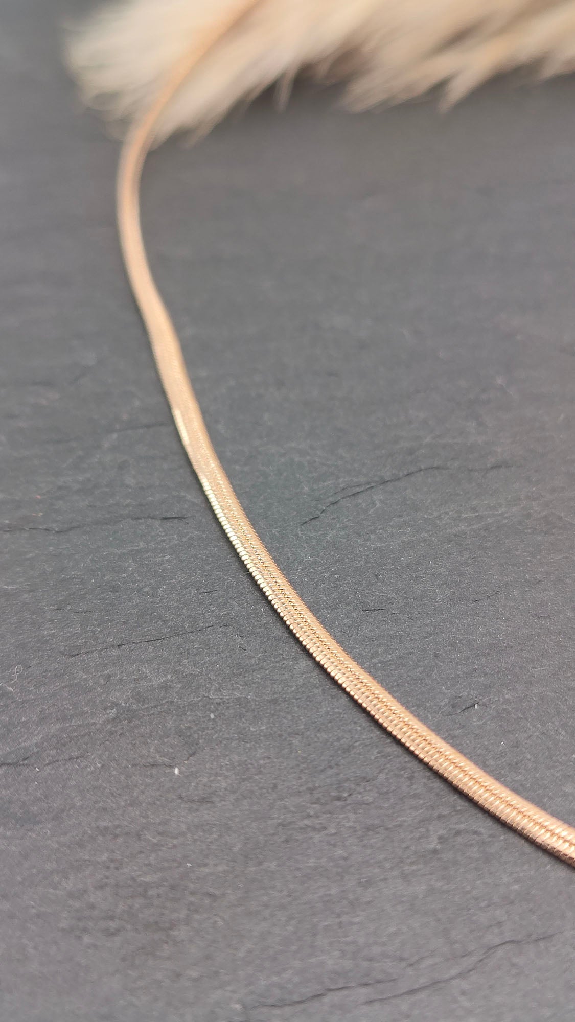 Lucinda Sleek Snake Chain Necklace featuring a smooth, flowing design with a polished finish, perfect for layering or wearing alone.