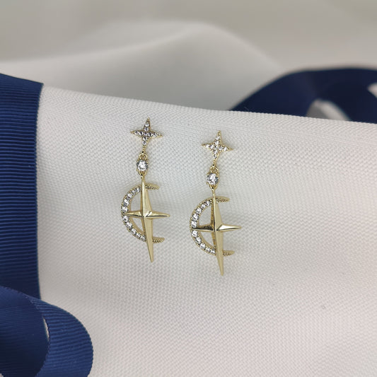 Gold-tone drop earrings with a small star and a crescent moon set with cubic zirconia