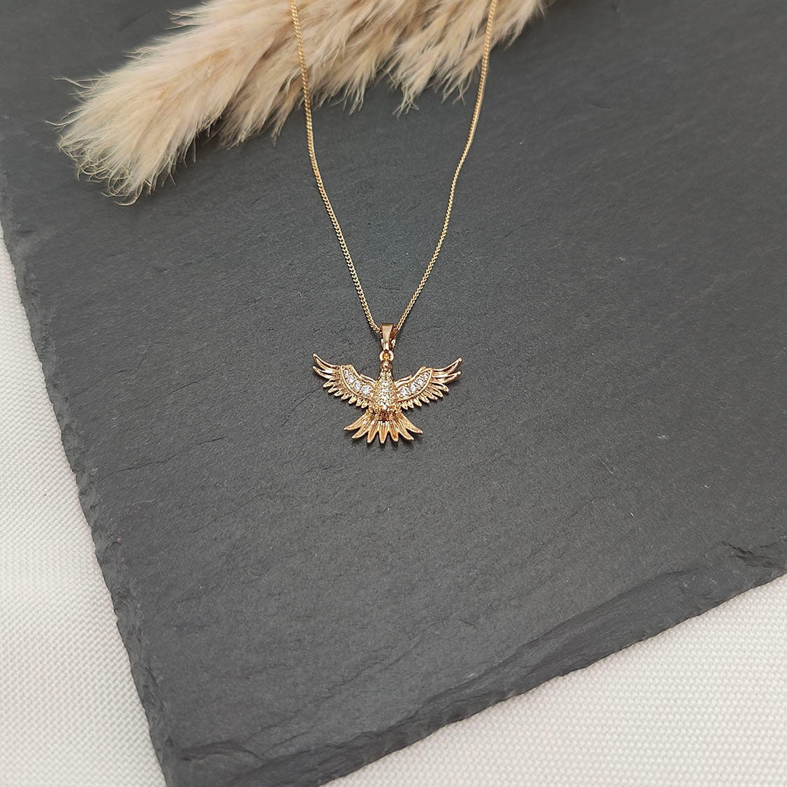 Phoenix Rising Necklace featuring a detailed Phoenix pendant with outstretched wings adorned with pavé gemstones.